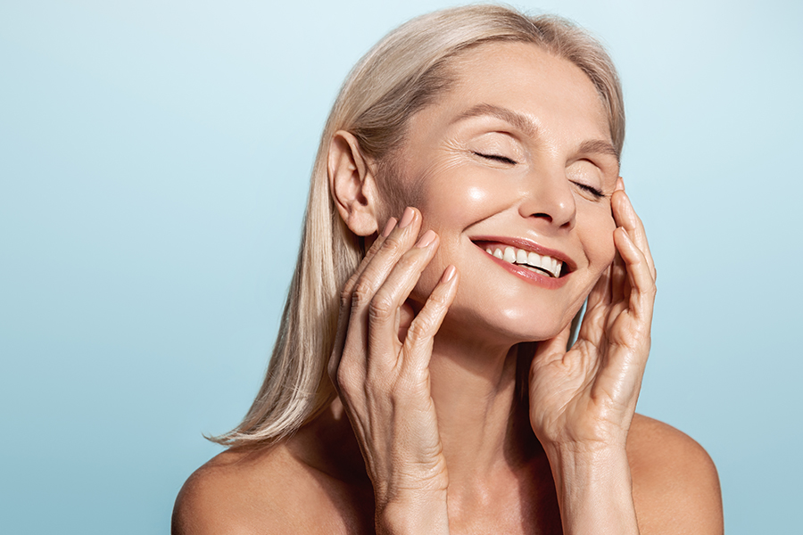Gorgeous Senior Older Woman With Closed Eyes Touching Her Perfect Skin