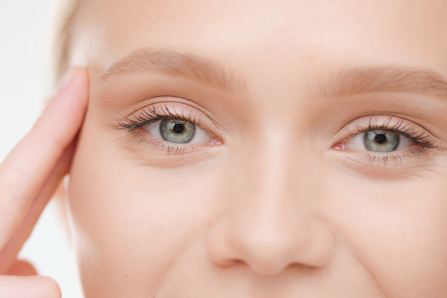Extreme Close-Up Shot Of Caucasian Blond Female Model Lifts Her Eye With Her Fingers