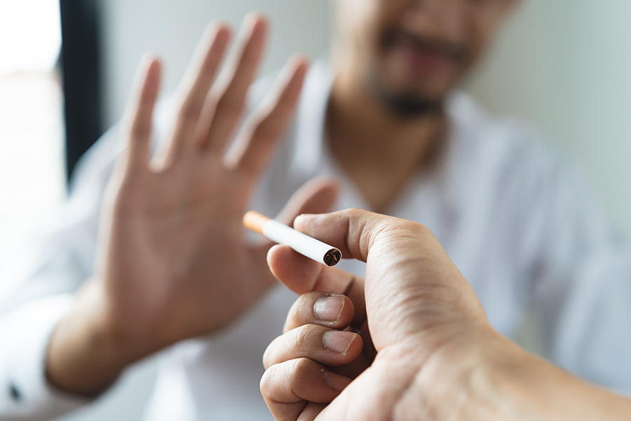 Close Up Hands Of Person Refusing To Smoke Cigarette
