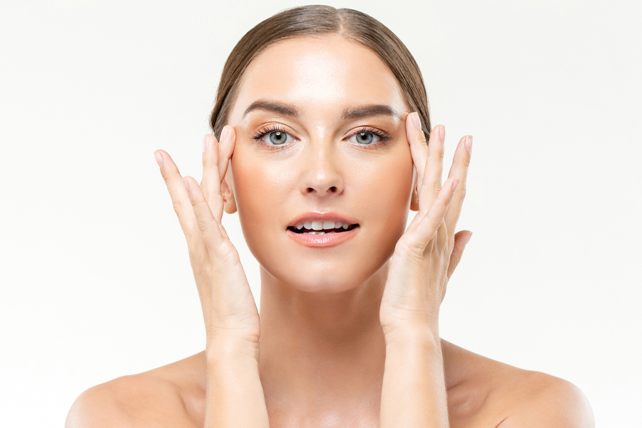 Attractive Caucasian Woman Massaging Face