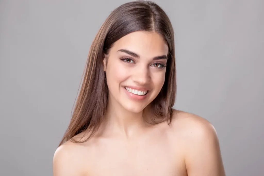 Beautiful young woman with perfect skin and open smile