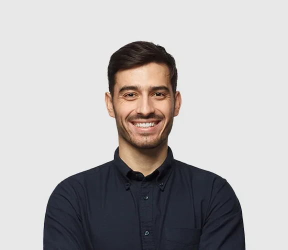 Handsome smiling business man in blue shirt isolated on gray background