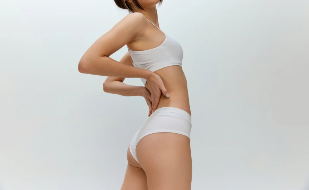 Healthy back, spine. Cropped image of fit healthy female body over grey studio background