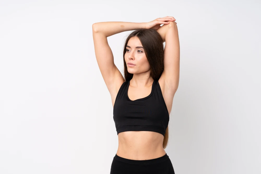 Young Sport Woman Over Isolated White Background Stretching
