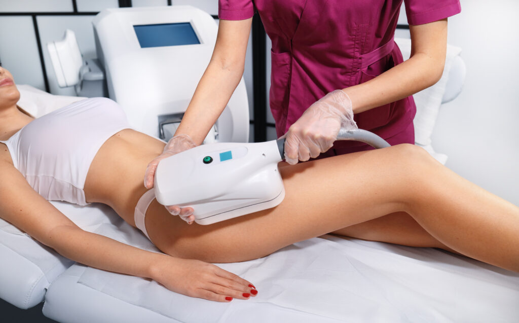 Patient receiving non-surgical liposuction treatment for fat reduction on thighs and abdomen.