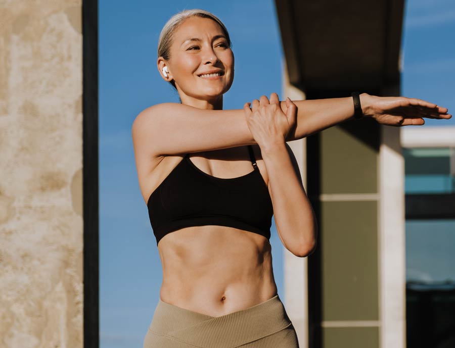 Studio shot of a young beautiful woman with long gorgeous hair posing against a grey background.