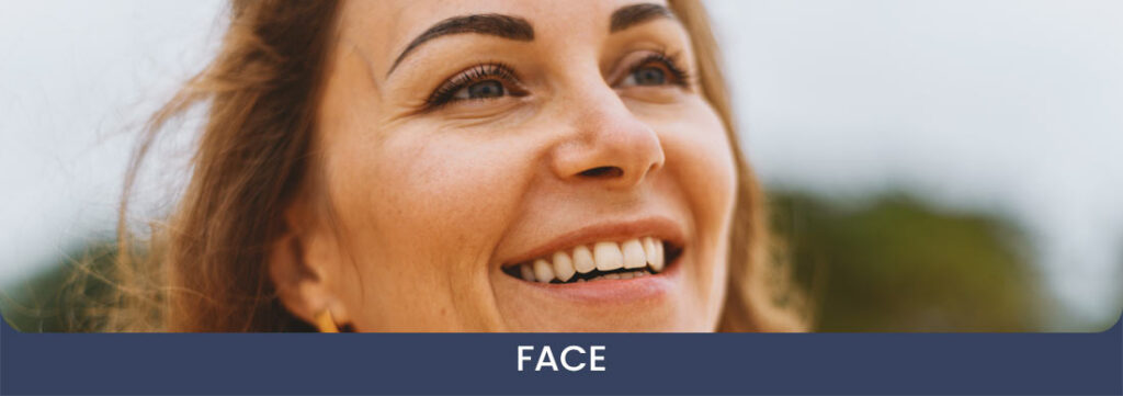 Photo of a middle age woman smiling looking up towards the sky - face category procedure cover