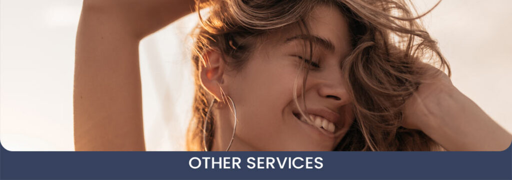 Cheerful pretty girl with closed eyes, long blonde hair, stylish accessories smiling and posing against background of pink sunset sky